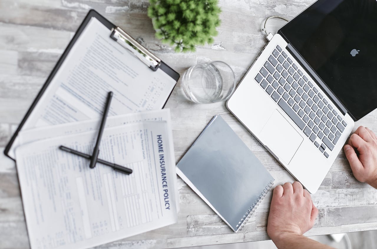 Healthcare documents and laptop on a desk