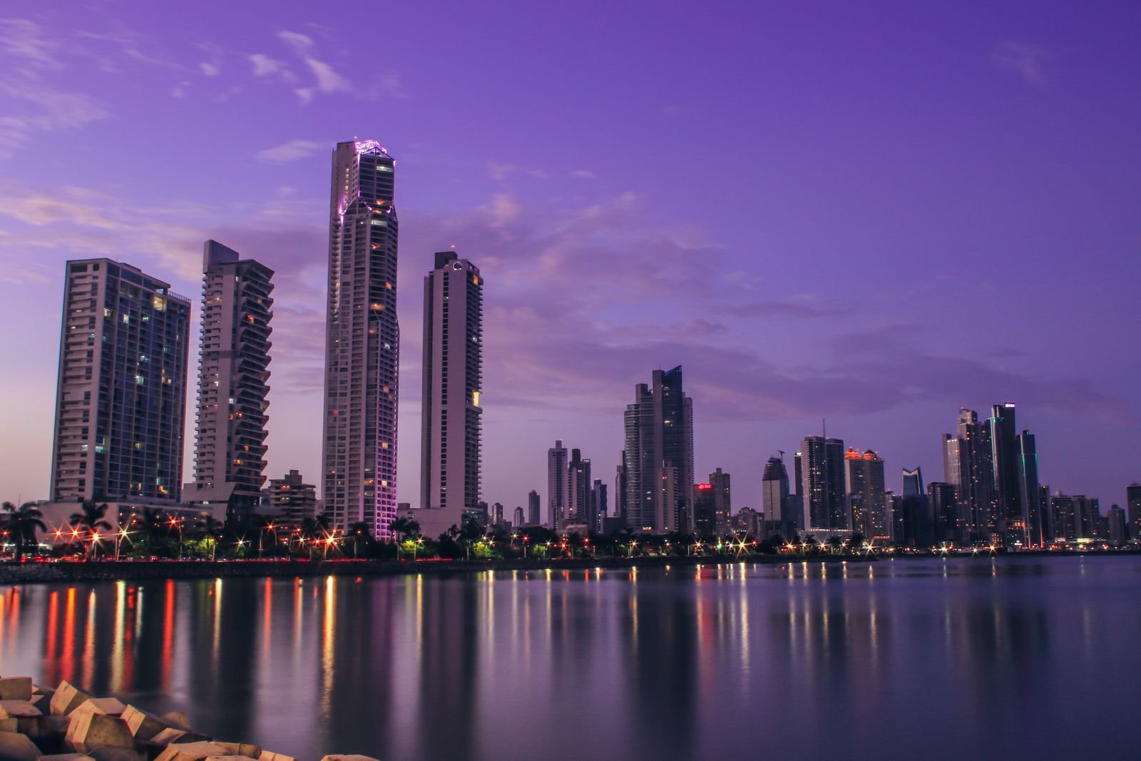 Panama City's skyline at night — Johns Hopkins-affiliated cardiology and the fastest residency on the list, but a private-first system that runs into the underwriting wall. Photo: Pexels.